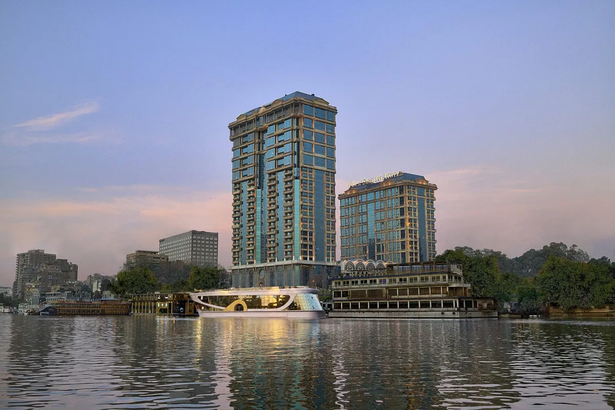 Four Seasons Hotel Cairo at The First Residence rising over the Nile at dusk